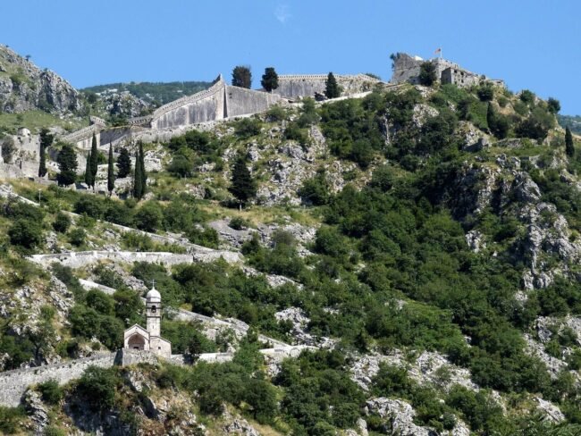 Kotor Fortress hike Montenegro  panoramic view of Kotor Old Town and the Bay of Kotor from the ancient St John Fortress walls 