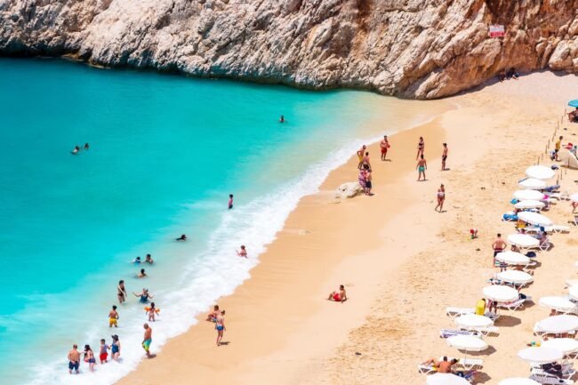 Montenegro in July summer  Budva beach crowded with tourists and beach umbrellas representing peak season heat and crowds