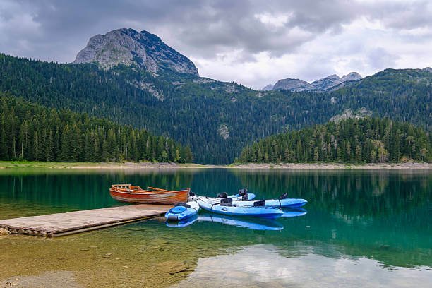 Best time for hiking in Montenegro Durmitor National Park in October with vivid red and gold autumn colours on mountain slopes